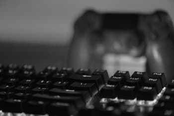 a close up of a keyboard and a video game controller