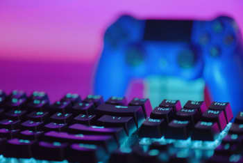 a close up of a keyboard and a video game controller
