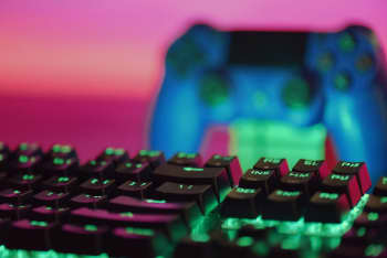 a close up of a keyboard and a video game controller